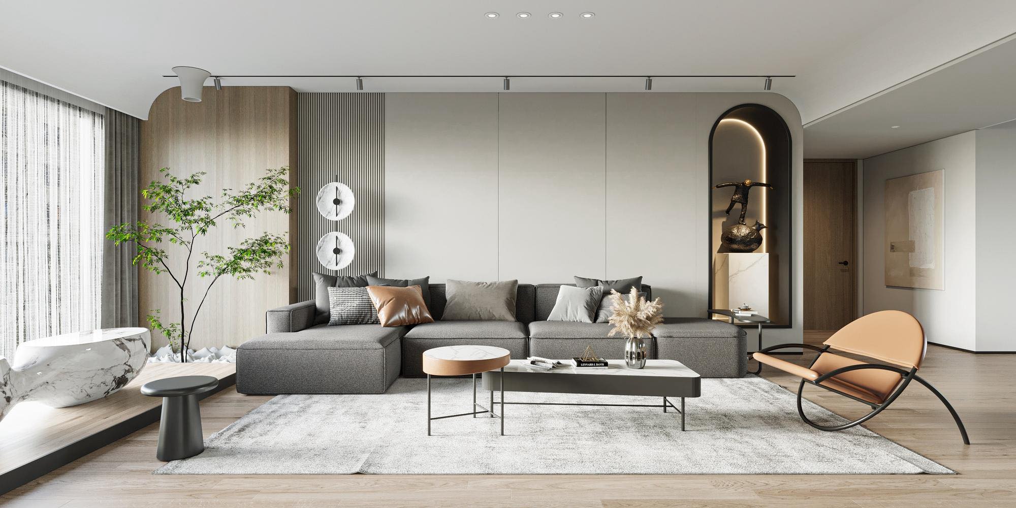 Salón diseñado por un estudio de interiorismo, con sofá gris, butaca de cuero y paneles de madera